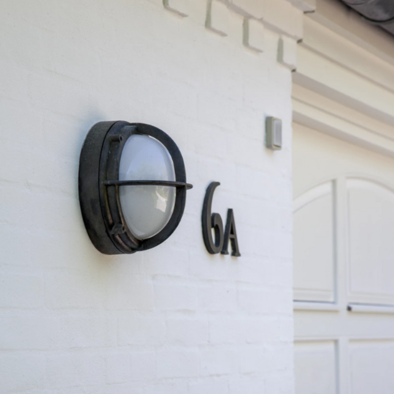 The Skot Wall from Louis Poulsen in a driveway.