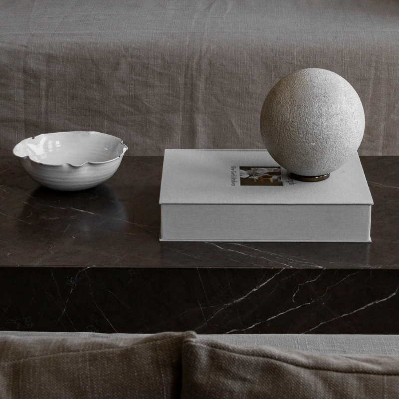 Black marble coffee table in minimalistic designed living room