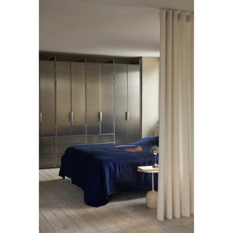 The Flowerpot VP9 Portable Table Lamp from &Tradition in a bedroom.