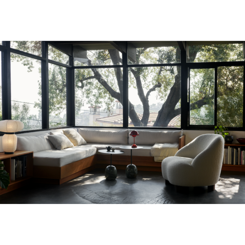 The Flowerpot VP9 Portable Table Lamp from &Tradition in a lounge area with sofas and chairs.