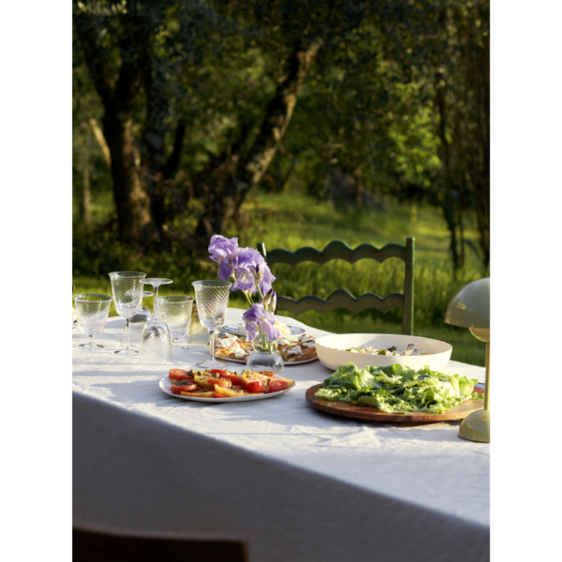 The Flowerpot VP9 Portable Table Lamp from &Tradition in an outdoor dining set up.