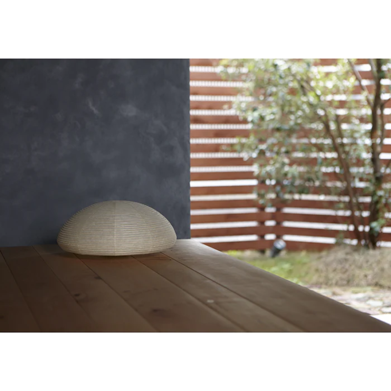 The Paper Moon 4 nestled outside on a porch overlooking a garden during the day.