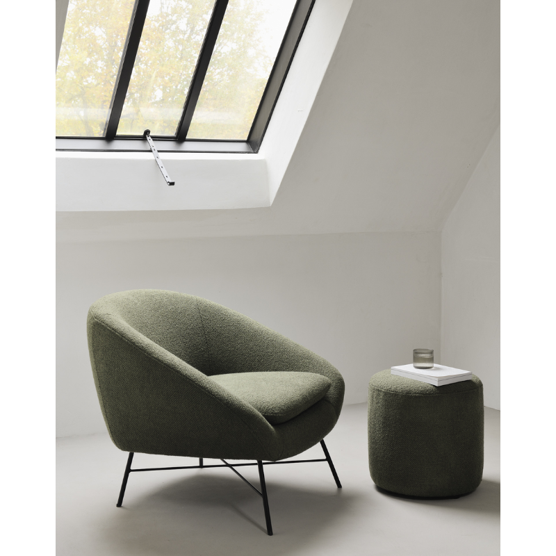 The Barrow Lounge Chair from Ethnicraft within a bedroom.