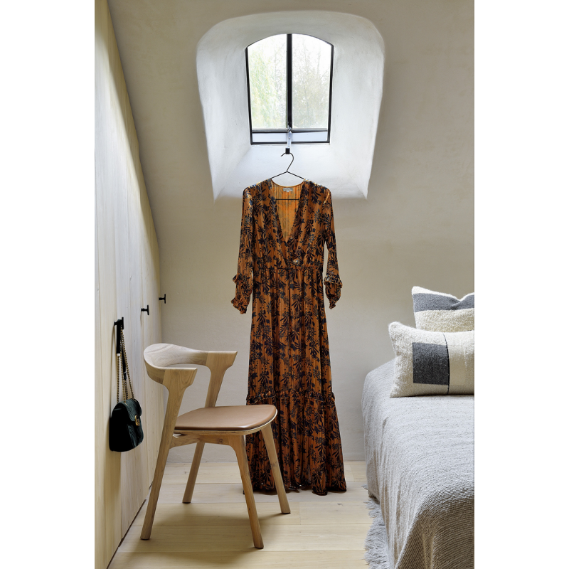 The Bok Dining Chair from Ethnicraft in a bedroom.