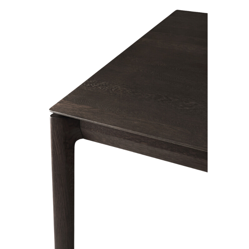 The Bok Dining Table from Ethnicraft in brown oak, in a detailed close up.