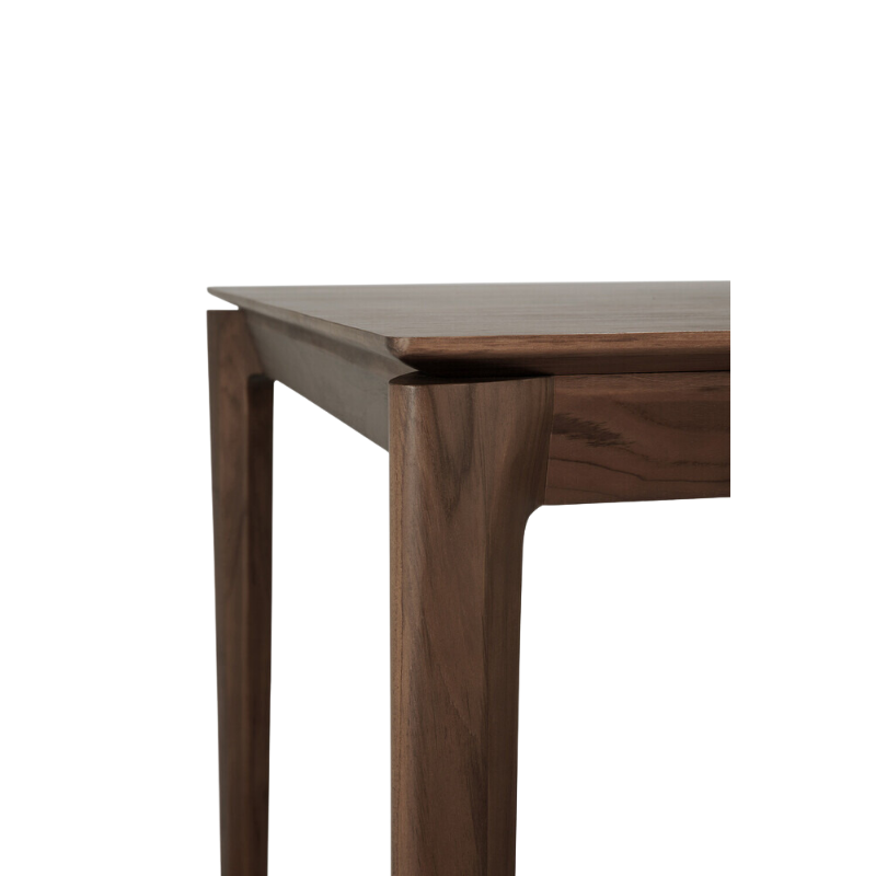 The Bok Dining Table from Ethnicraft in brown teak, up close, showing the texture of the brown teak.
