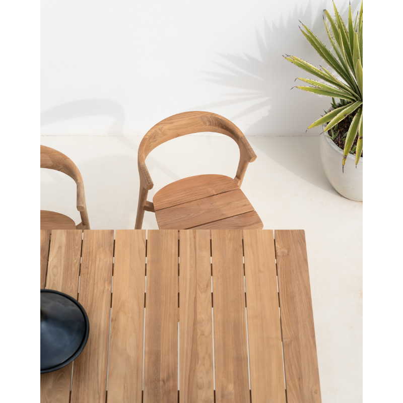 The Bok Outdoor Dining Chair from Ethnicraft in a close up lifestyle shot, featuring the Bok Dining Chair and Dining Table.