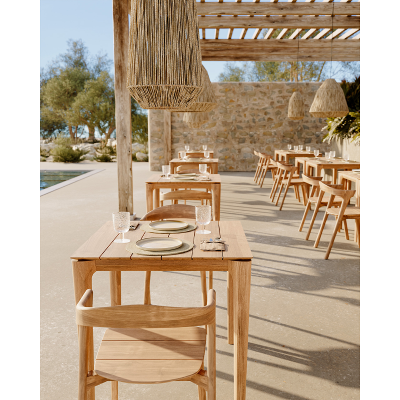 The Bok Outdoor Dining Table from Ethnicraft in a cafe.