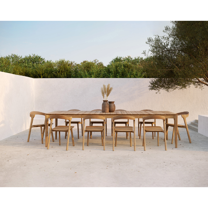 The Bok Outdoor Dining Table from Ethnicraft in an outdoor dining space.