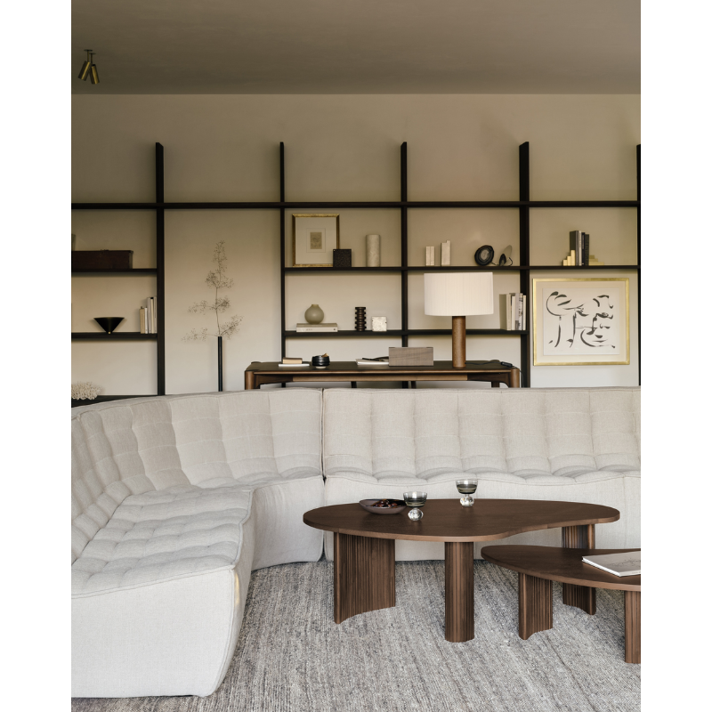 The Boomerang Coffee Table from Ethnicraft in a family area.