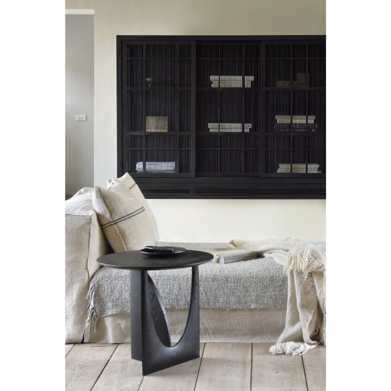 The Geometric Side Table from Ethnicraft within a bedroom.