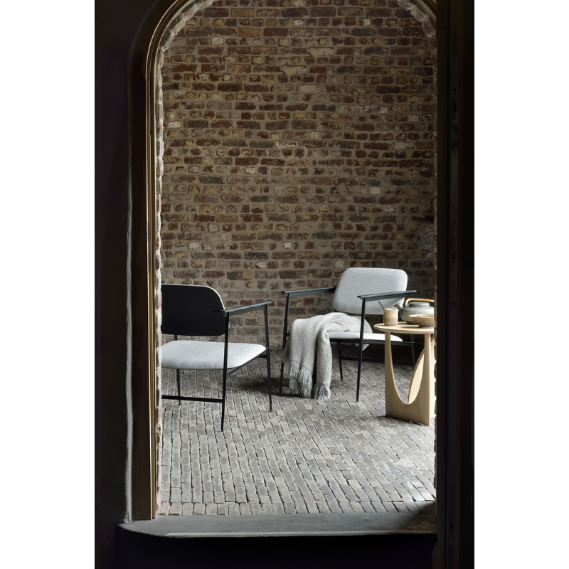 The Geometric Side Table from Ethnicraft in a courtyard.