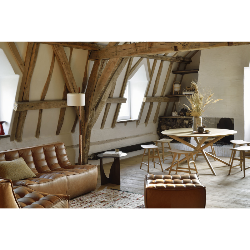 The Geometric Side Table from Ethnicraft in an open space home featuring a dining and living space.