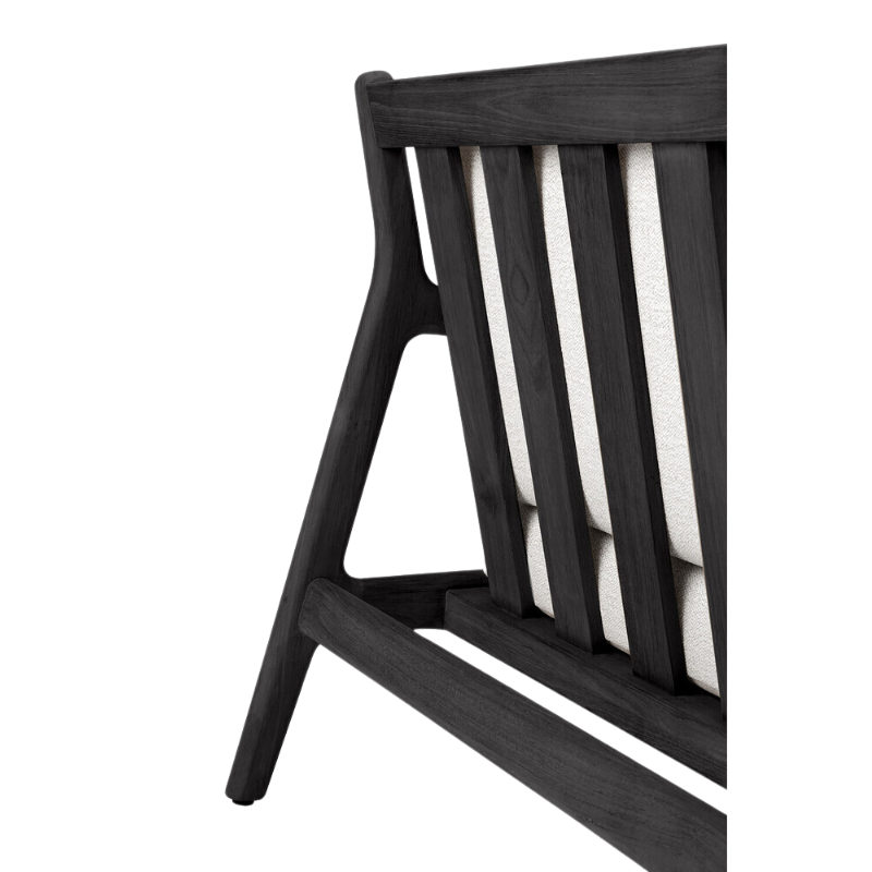 The Jack Outdoor Lounge Chair from Ethnicraft made from solid teak tainted and brushed black with the off white cushion.