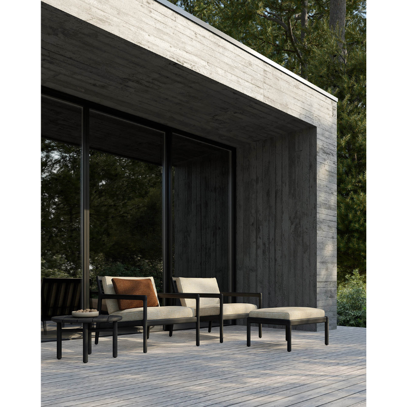 The Jack Outdoor Lounge Chair from Ethhnicraft on a patio with other Ethnicraft projects.