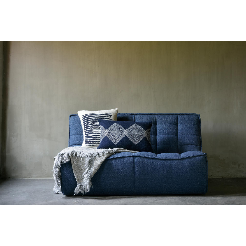 The Linear Diamonds Cushion from Ethnicraft in a lounge lifestyle photograph.