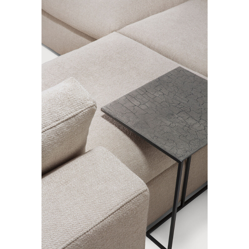 The Mellow Footstool from Ethnicraft being used with a tray table above it.