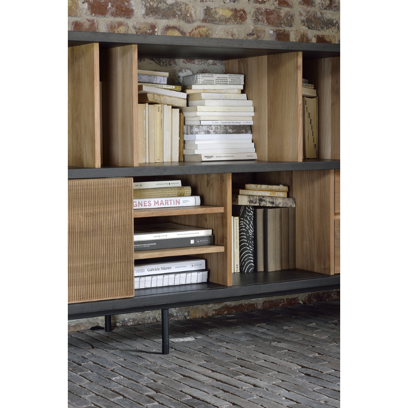 The Oscar sideboard in solid teak by Alain van Havre is the perfect multi-tasker: its open spaces can be used to exhibit personal objects, whereas the sliding doors offer the option of organizing documents out of sight. Notice the exceptional grooves in the doors: each narrow groove was carefully hand carved, making every Oscar piece unique.