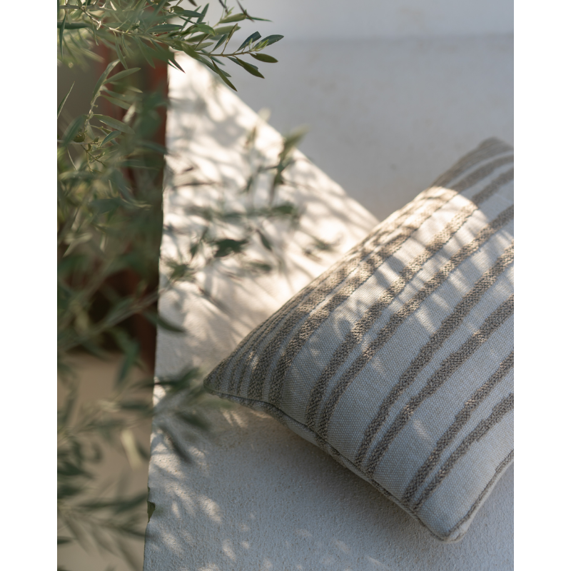 The Stripes Outdoor Cushion from Ethnicraft in an outdoor living area.