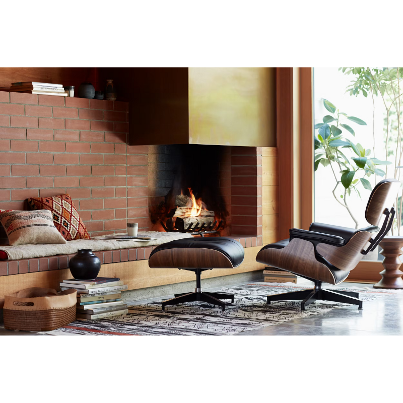The Eames Lounge Chair and Ottoman from Herman Miller in a cabin beside a fire. all-groups