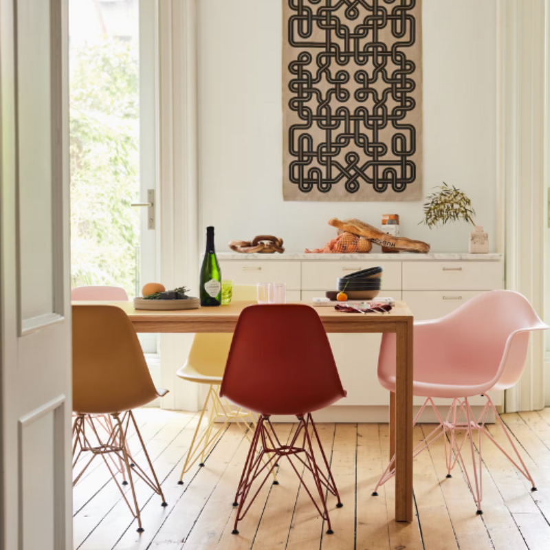 The Eames Molded Plastic Armchair by Herman Miller x HAY in a dining room.