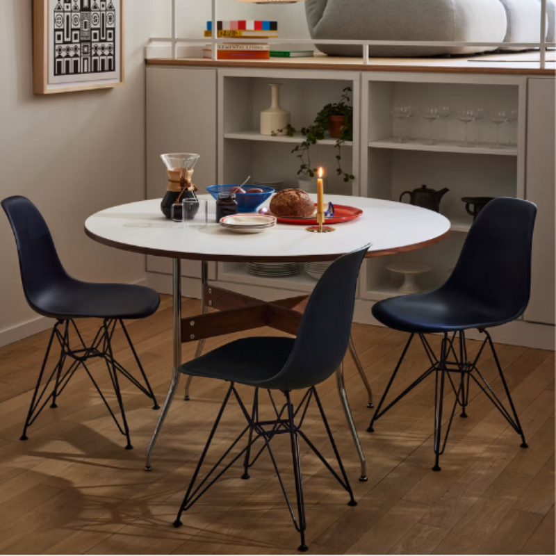 The Eames Molded Plastic Side Chair from Herman Miller designed by Herman Miller x HAY around a dining table.