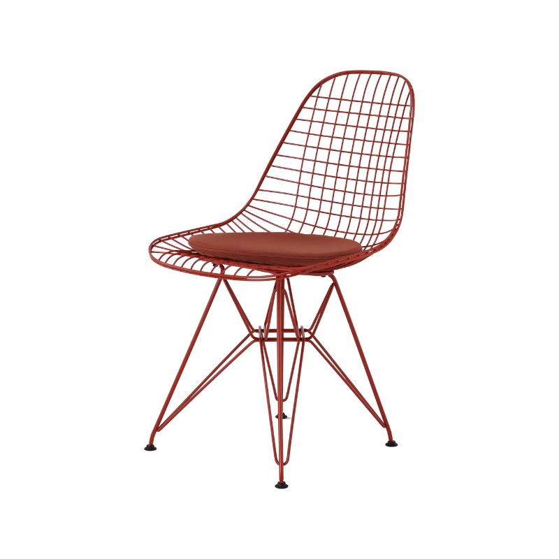 The Eames Wire Chair from Herman Miller, designed by Herman Miller x HAY in iron red with a color matching seat pad.