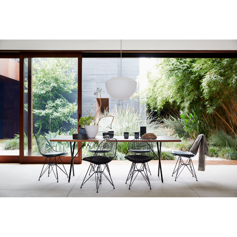 The Nelson Apple Bubble Pendant from Herman Miller illuminating a dining room.