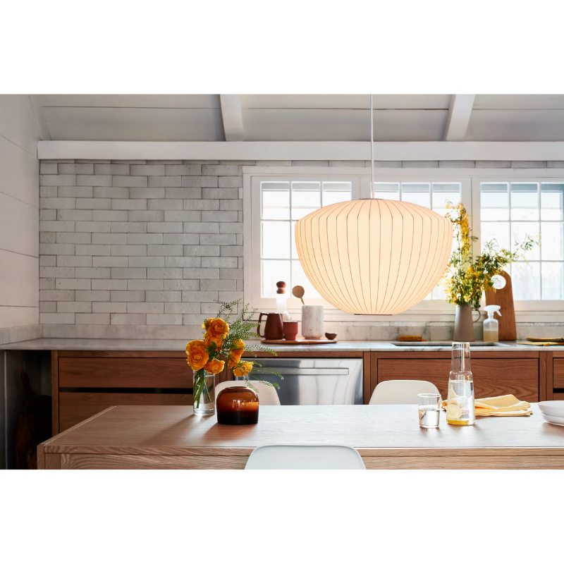 The Nelson Apple Bubble Pendant from Herman Miller above a dining table.