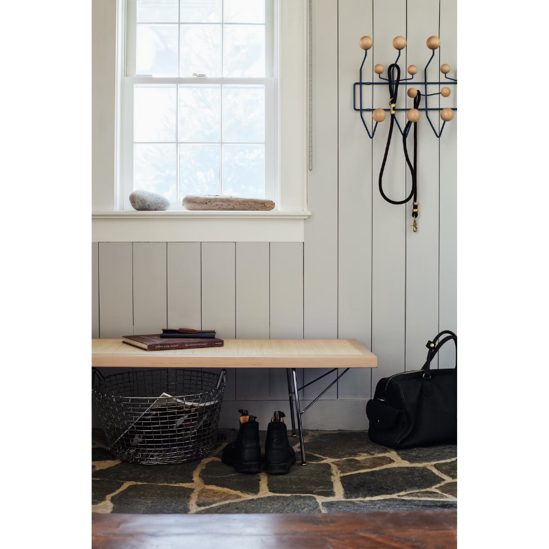 The Nelson Cane Bench from Herman Miller within a family space.