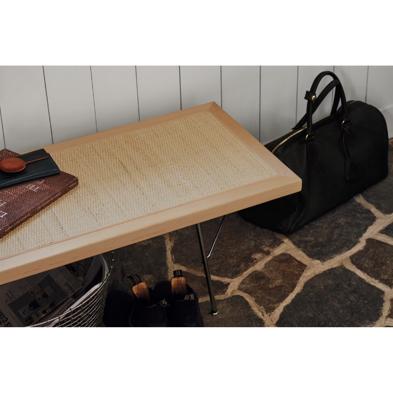 Offering a pleasing mix of materials, the richly textured cane is surrounded by a wood frame and stands on metal legs. Because the cane is taut but gives ever so slightly, this bench is ideally suited for use as a seat, table, or both.