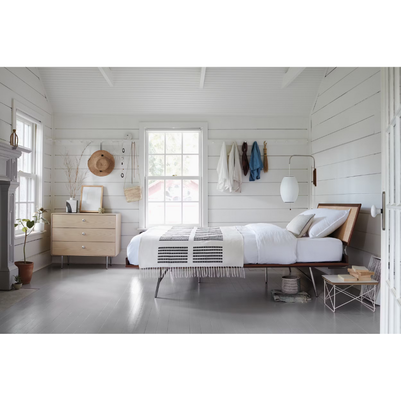 The Nelson Cigar Wall Sconce from Herman Miller in a bedroom.