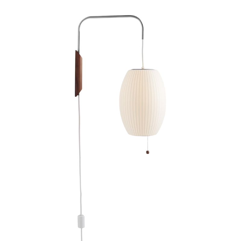 The Nelson Cigar Wall Sconce from Herman Miller turned on within a studio.