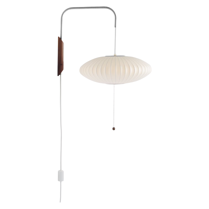 The Nelson Saucer Wall Sconce from Herman Miller turned on.