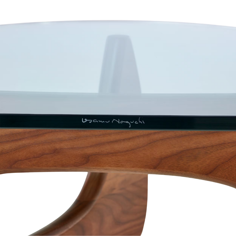 The Noguchi Table from Herman Miller in walnut in a close up photograph showing the signature.