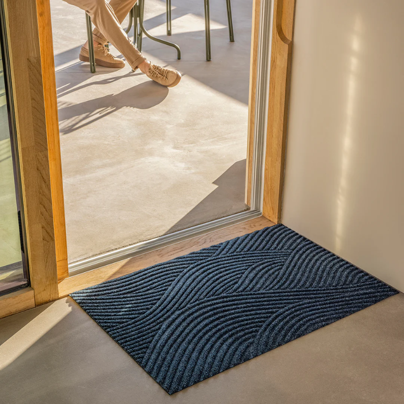 The Sjø Doormat from Heymat in the large size in an entrance, indoors.