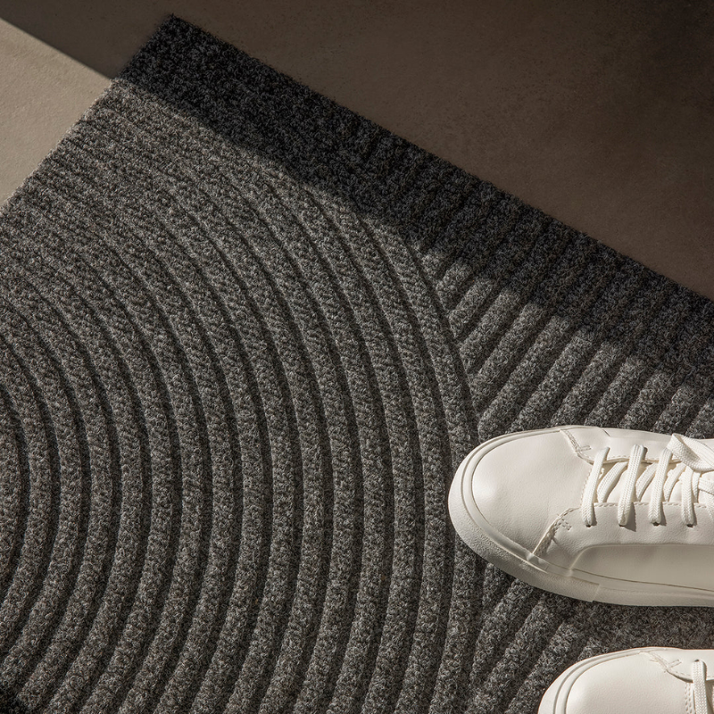 The Stein Doormat from Heymay in a living room.
