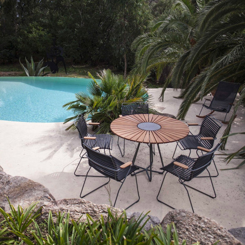 CLICK outdoor dining armchair is simple, honest, and ergonomically well thought out. It is beautiful in its repetition around the table and because the slats (lamellas) can be replaced, you can mix and change the colors as often as you like. These outdoor dining chairs are stackable and easy to store.
