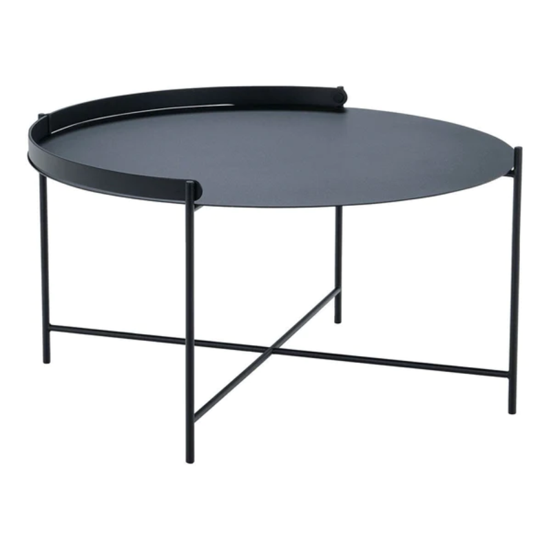 The EDGE tray table is a versatile piece of furniture that can be used both indoors and outdoors. It is made of powder-coated metal and comes in three different sizes. The half-ring shaped handle makes it easy to move the table between the living room and the garden, and when laid down it functions as a table edge making sure everything stays in place.