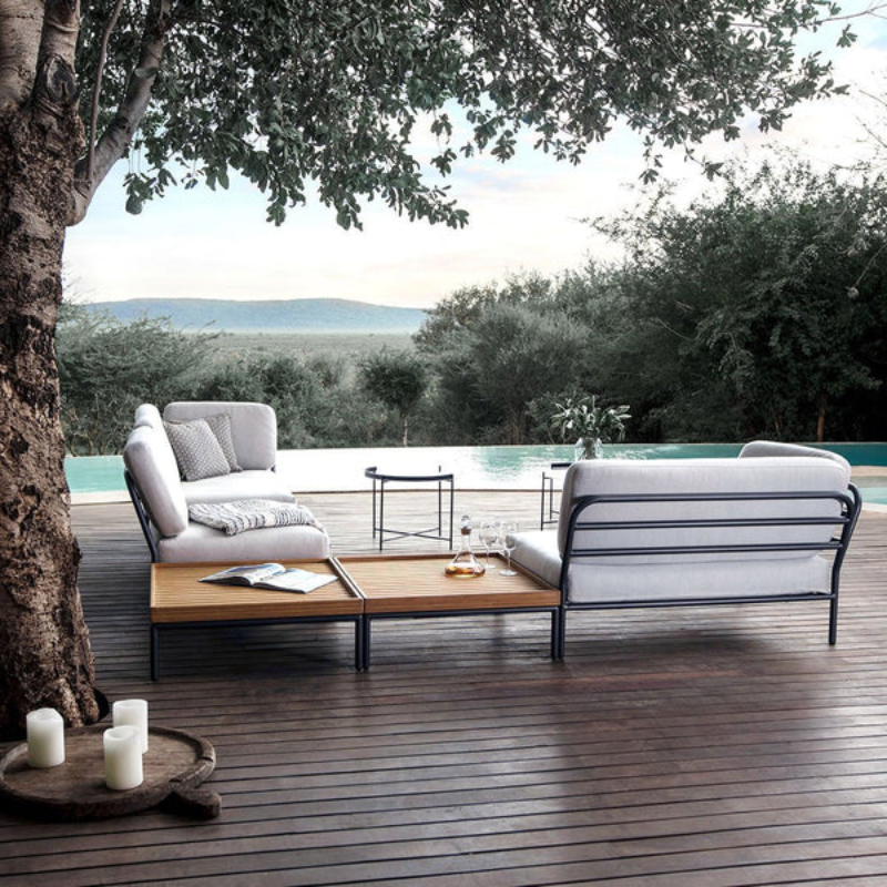 The EDGE tray table is a versatile piece of furniture that can be used both indoors and outdoors. It is made of powder-coated metal and comes in three different sizes. The half-ring shaped handle makes it easy to move the table between the living room and the garden, and when laid down it functions as a table edge making sure everything stays in place.