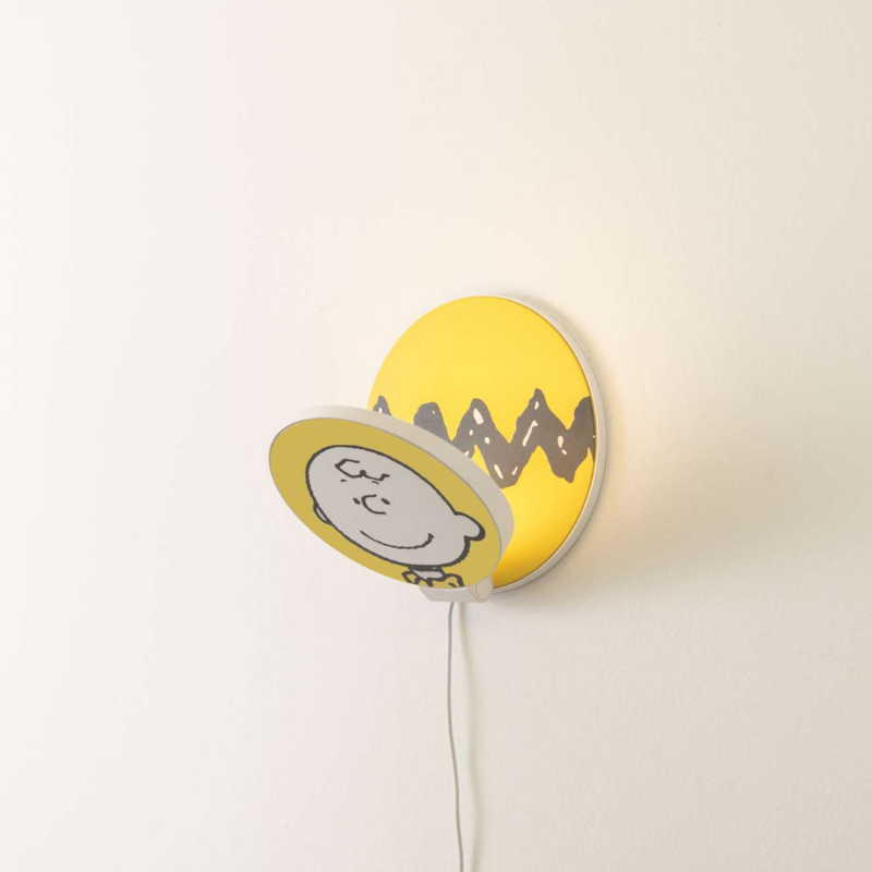 The Peanuts Edition Gravy Wall Sconce from Koncept in the Charlie Brown style from the side.