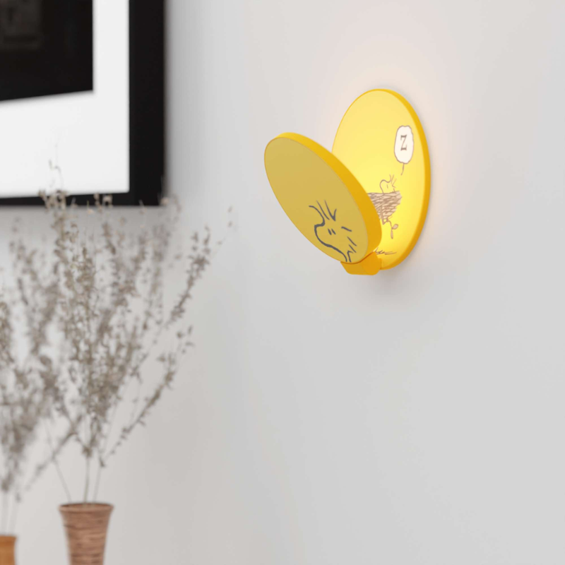 The Peanuts Edition Gravy Wall Sconce from Koncept in the Woodstock style in a living room.