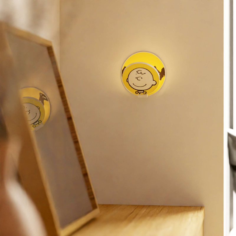 The Peanuts Edition Gravy Wall Sconce from Koncept in the Charlie Brown style in an office.
