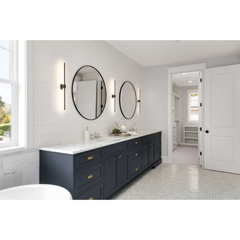 The Z-Bar Wall Sconce from Koncept in a his and her bathroom.