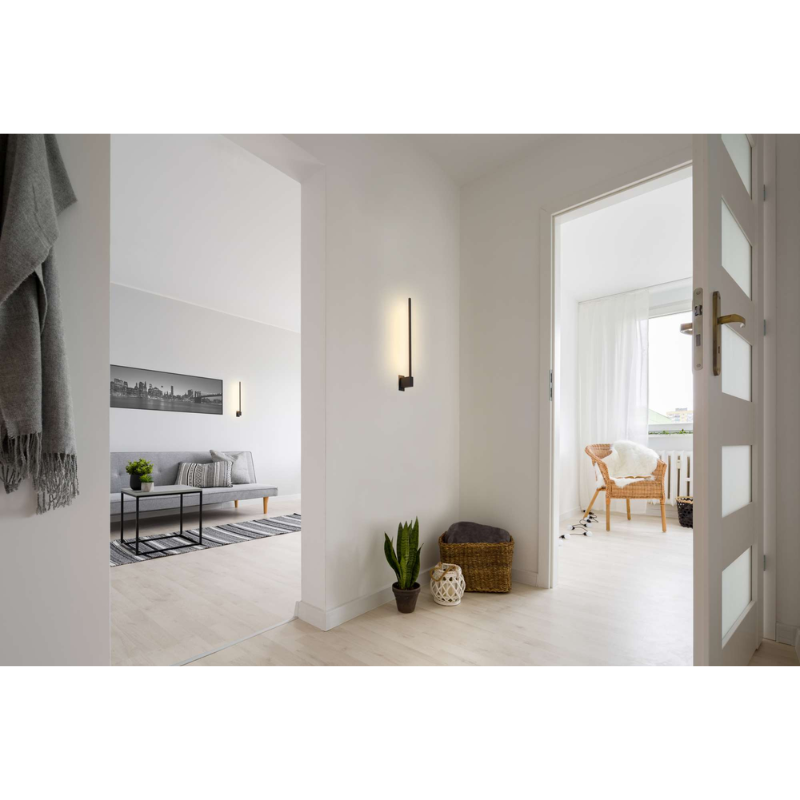 The Z-Bar Wall Sconce from Koncept in a family space between rooms.