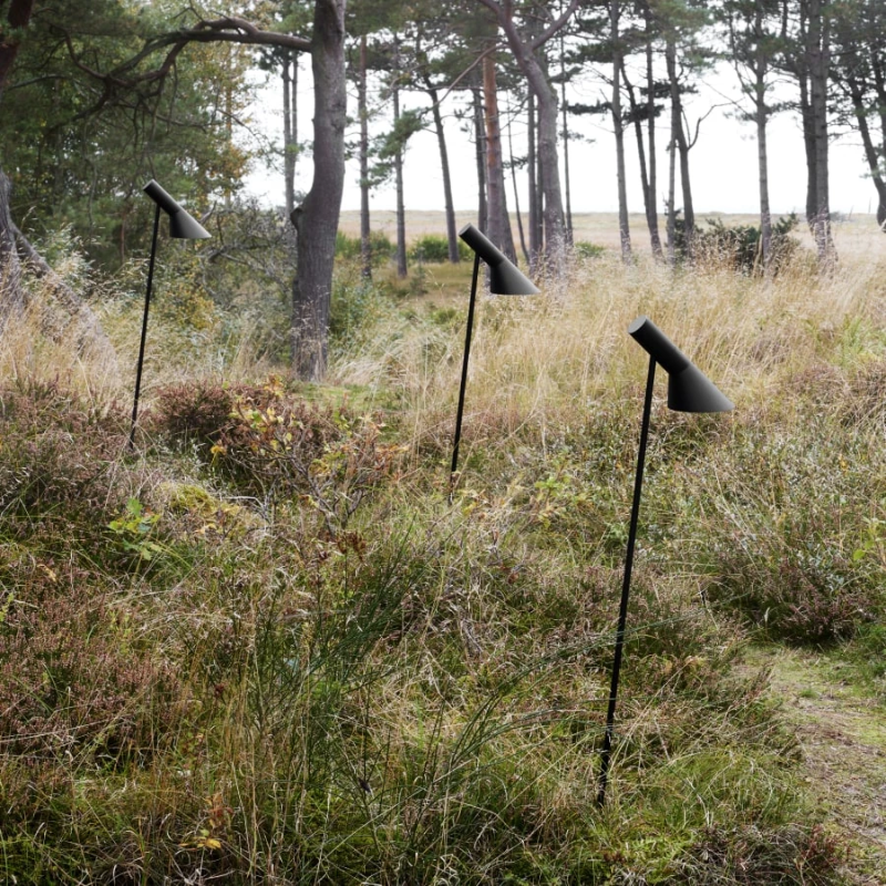 The AJ Garden Bollard from Louis Poulsen in a backyard.