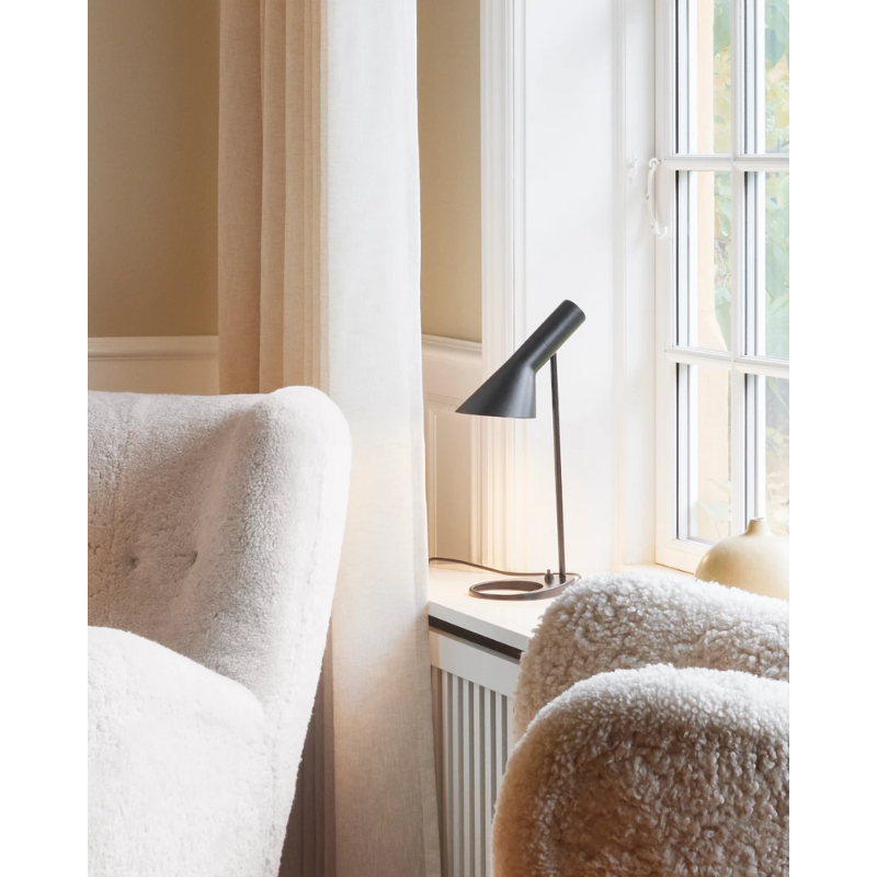 The AJ Mini Table Lamp from Louis Poulsen in a living room.