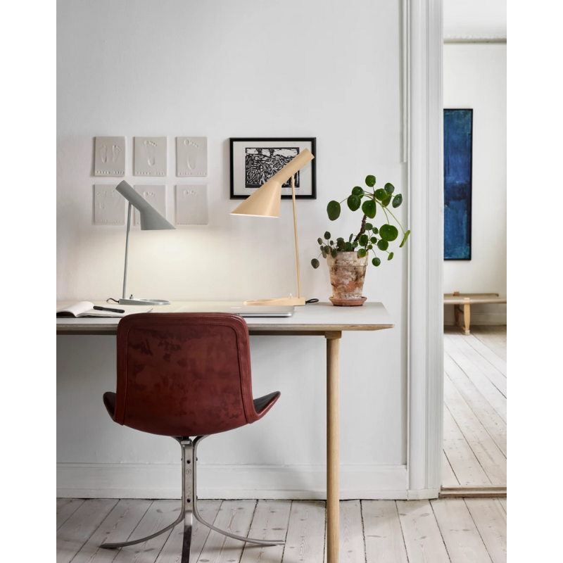 The AJ Mini Table Lamp from Louis Poulsen in a lounge.