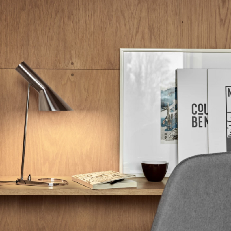 The AJ Mini Table Lamp from Louis Poulsen in an art studio.