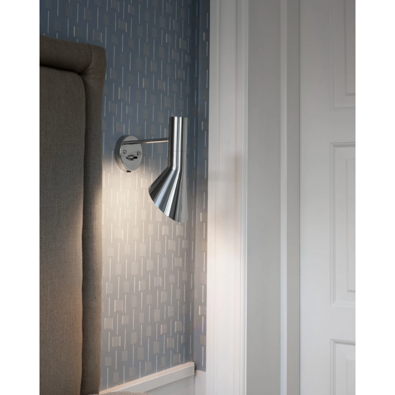 The AJ Wall from Louis Poulsen next to the entryway to a bedroom.